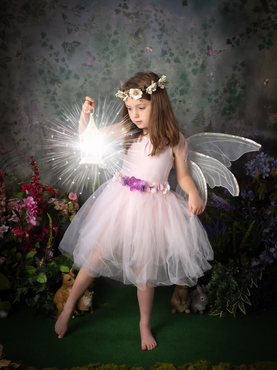 A fairy holds a glowing lantern