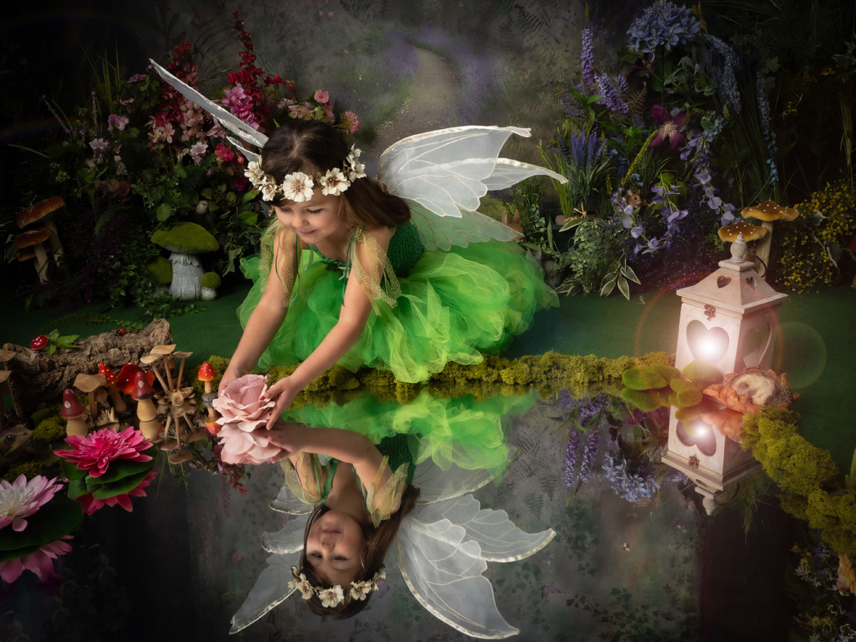 Flowers and woodland details surround a fairy portrait against the painted backdrop
